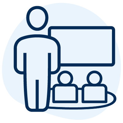 An icon of a teacher with children on a rug in front of a whiteboard.