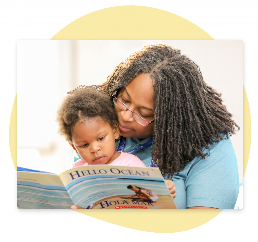 Micro-Cred Testimonial A teacher helping a young student through a picture book.